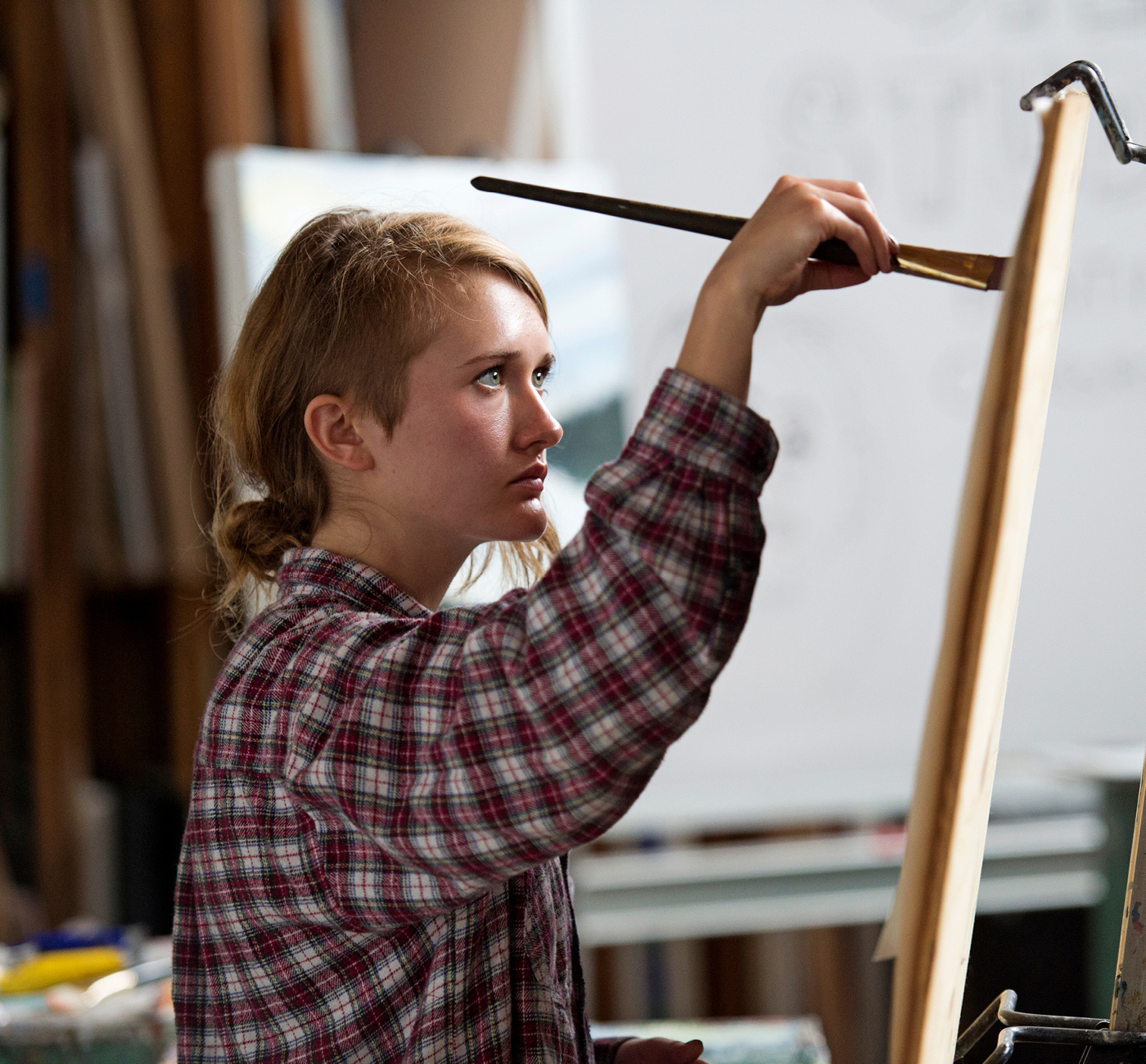 Woman painting at easel