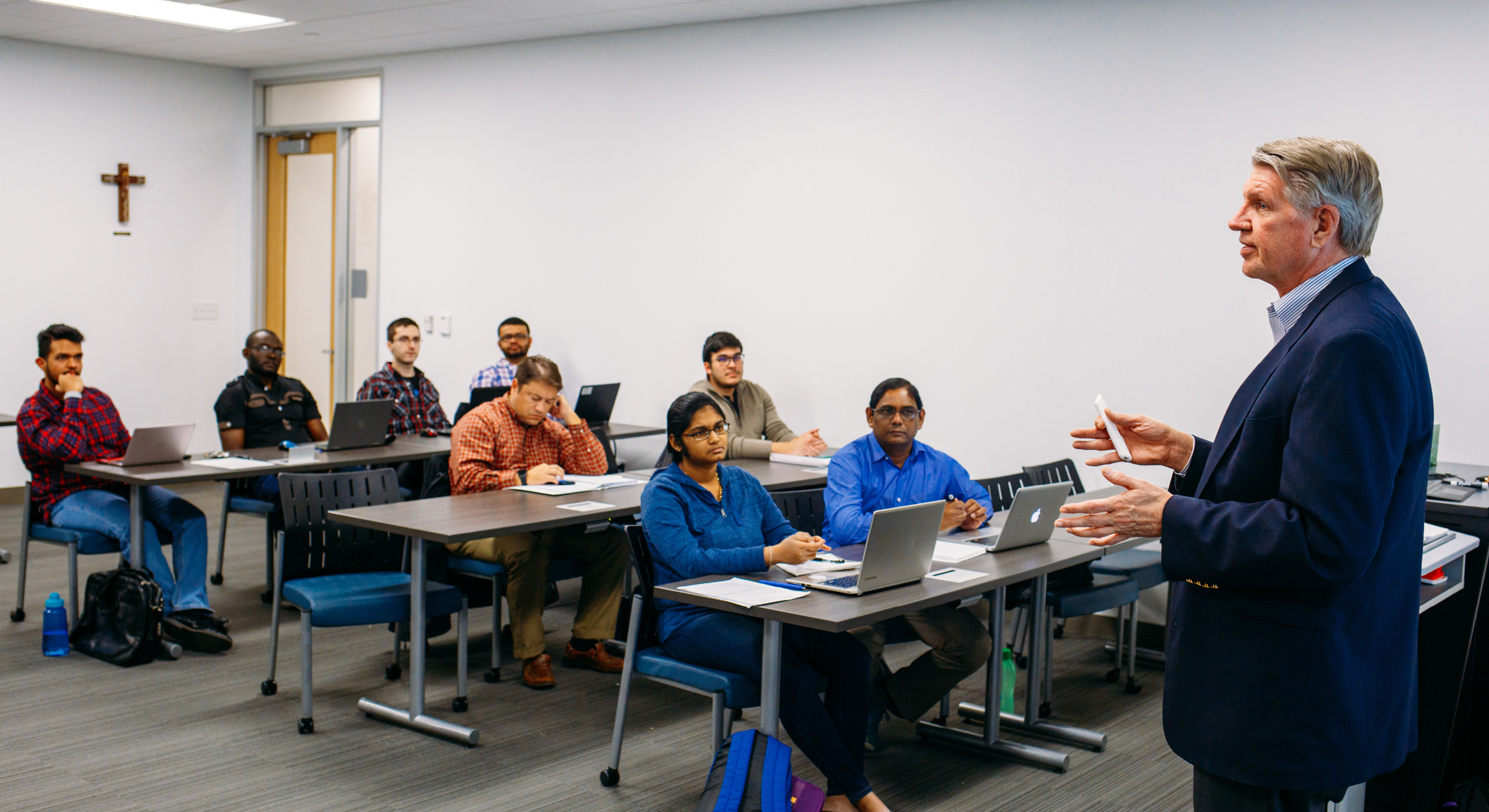 Master’s in finance students listen to a lecture by a finance professor.