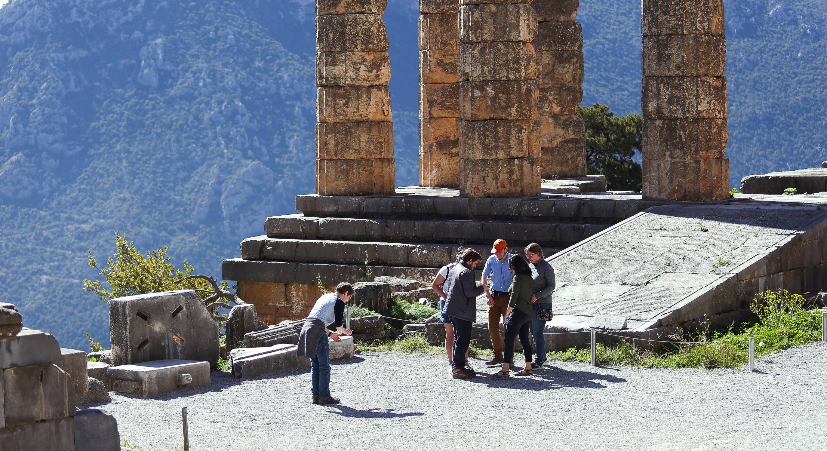 Students standing by ancient Greek columns