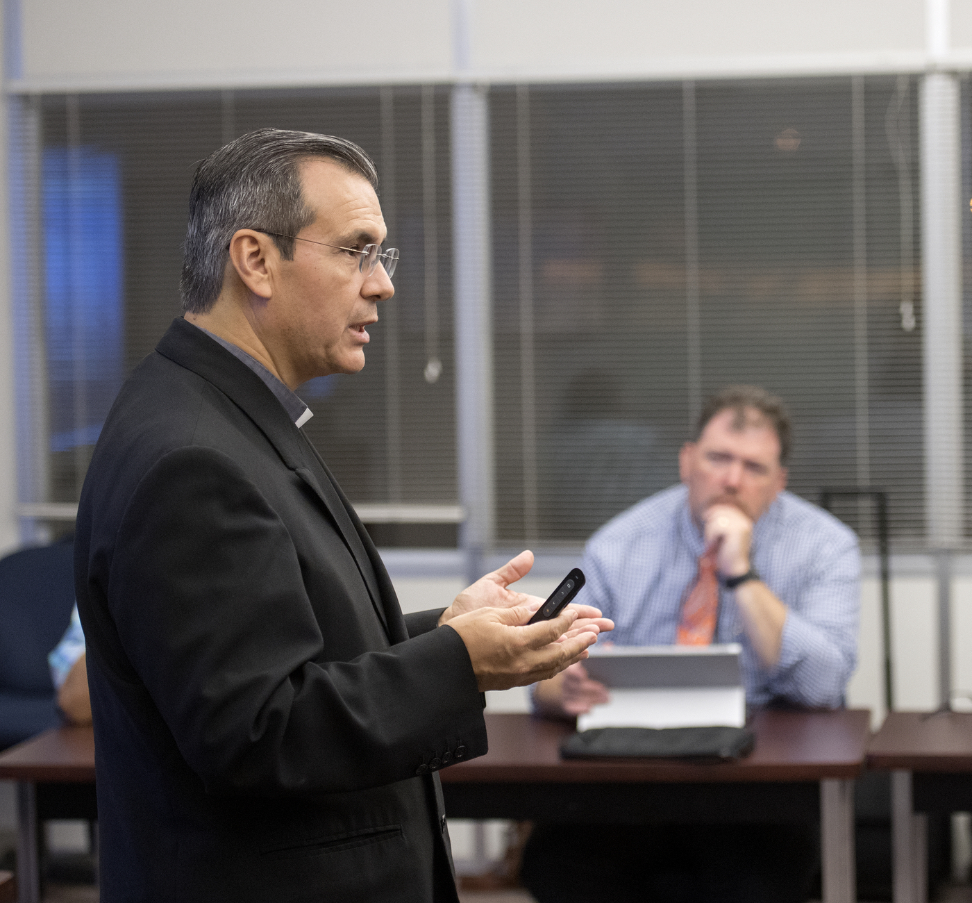 Father Rafael Ramirez teaches class