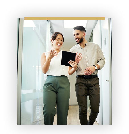 man and woman walking and talking down hallway